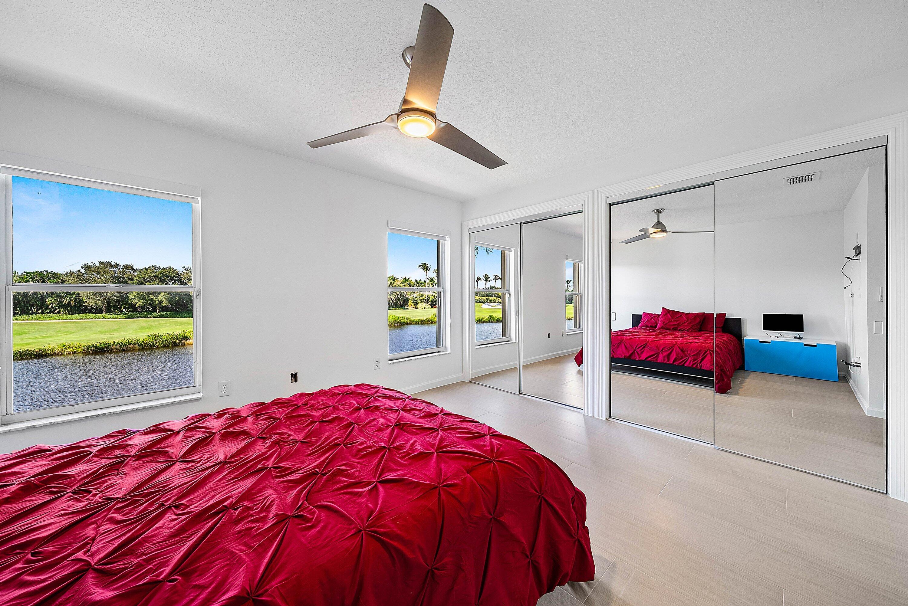 5855 Northwest 42nd Way Boca Raton, FL 33496 - Photo 35 of 77 a bedroom with a bed and a painting on the wall