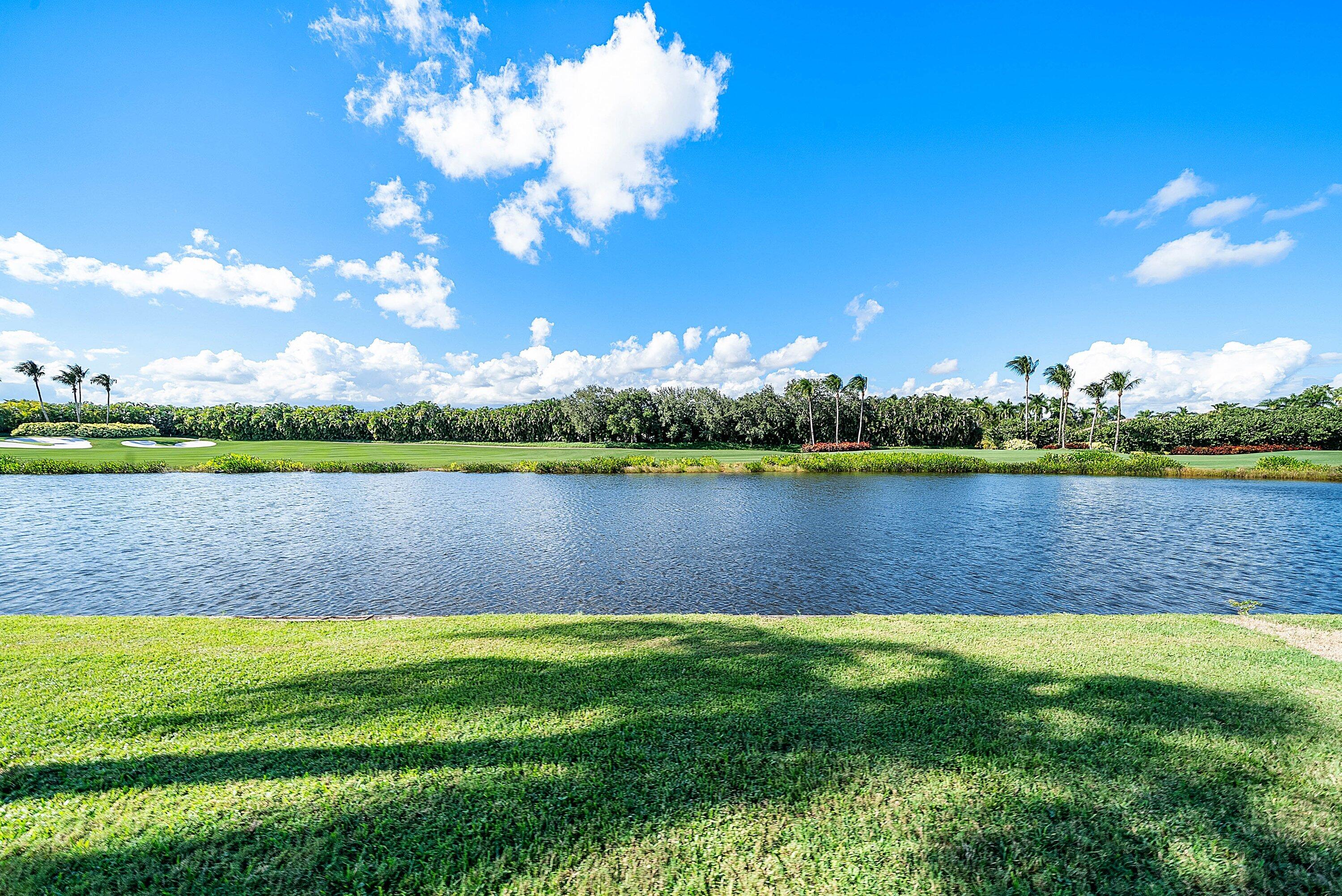 5855 Northwest 42nd Way Boca Raton, FL 33496 - Photo 40 of 77 a view of a lake with houses in the back