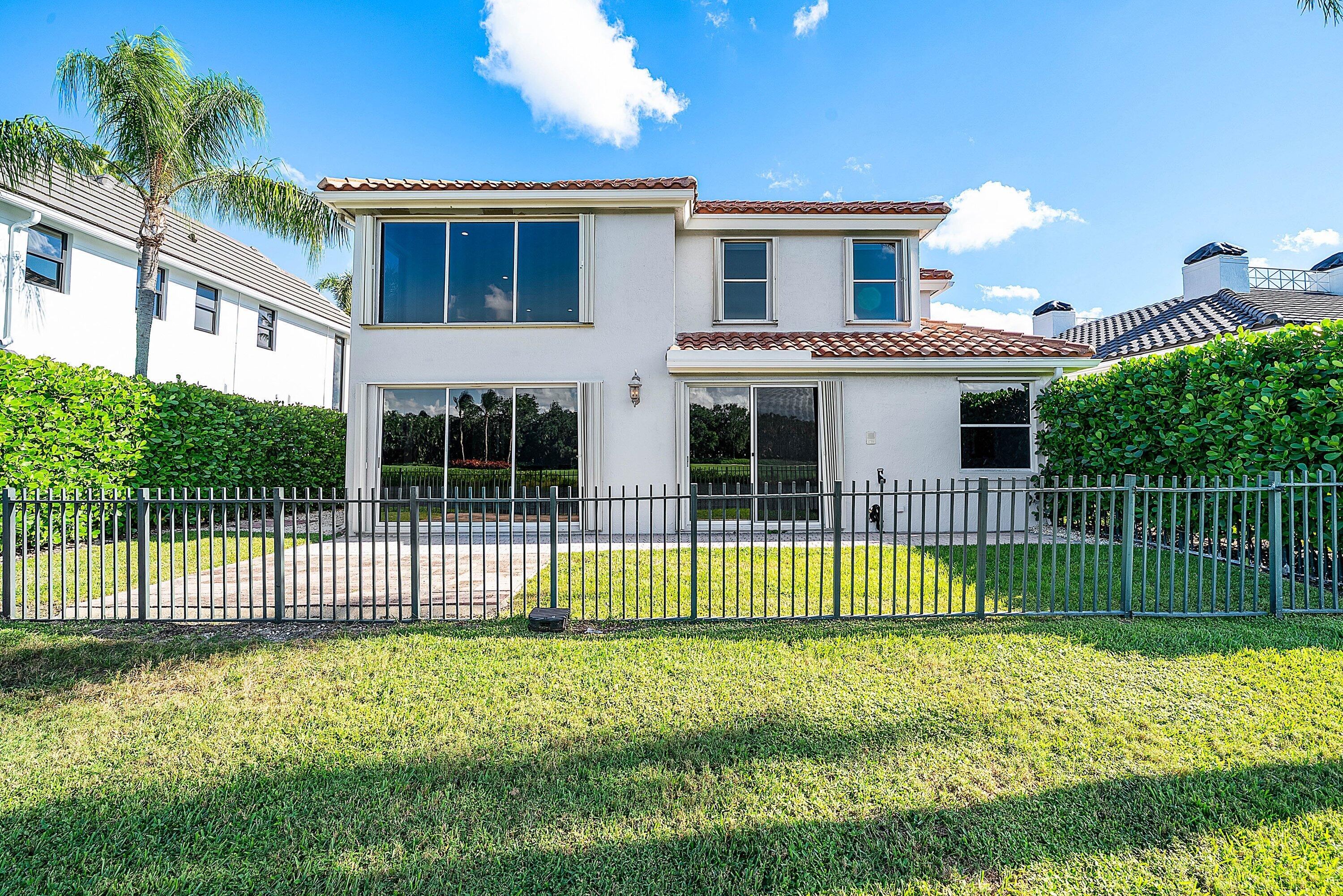 5855 Northwest 42nd Way Boca Raton, FL 33496 - Photo 42 of 77 a front view of a house with a garden and plants