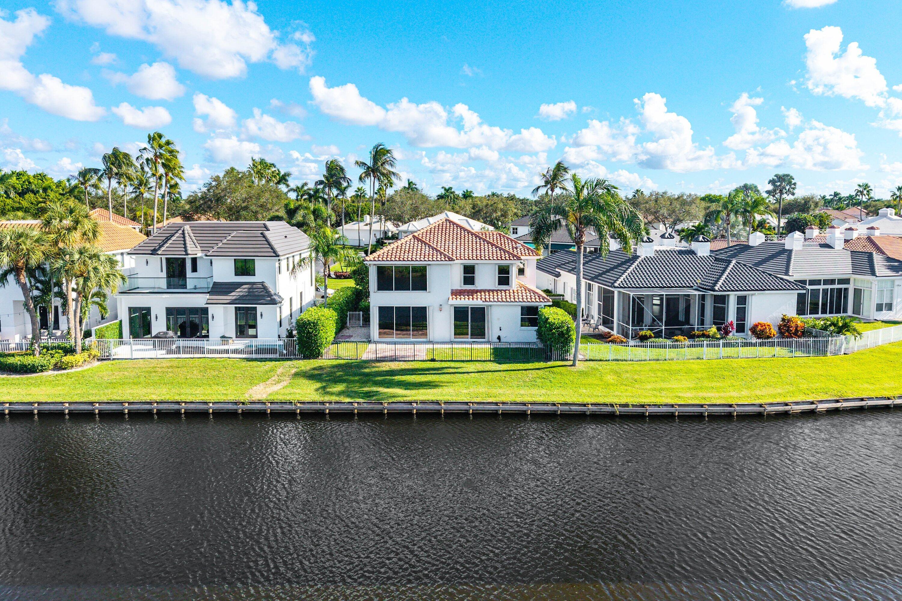 5855 Northwest 42nd Way Boca Raton, FL 33496 - Photo 50 of 77 a front view of a house with a swimming pool