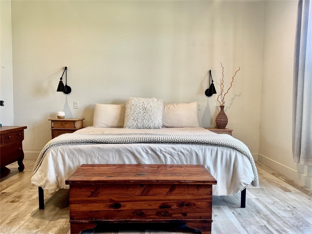 621 Stanton Road Johnson City, TX 78636 - Photo 14 of 40 a bedroom with a bed and a wooden floor