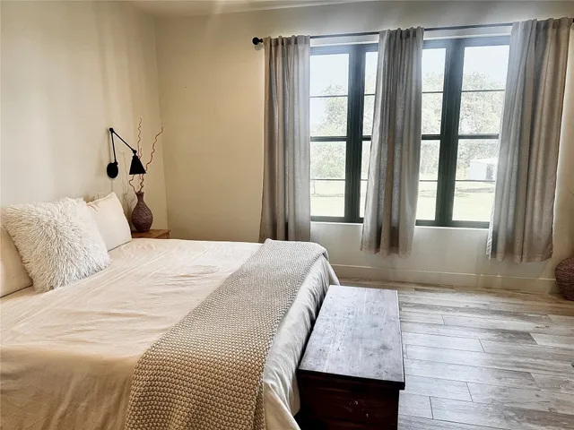 a bedroom with a bed window and walk in closet