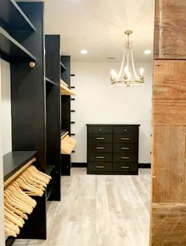 a bedroom with a bed and a chandelier