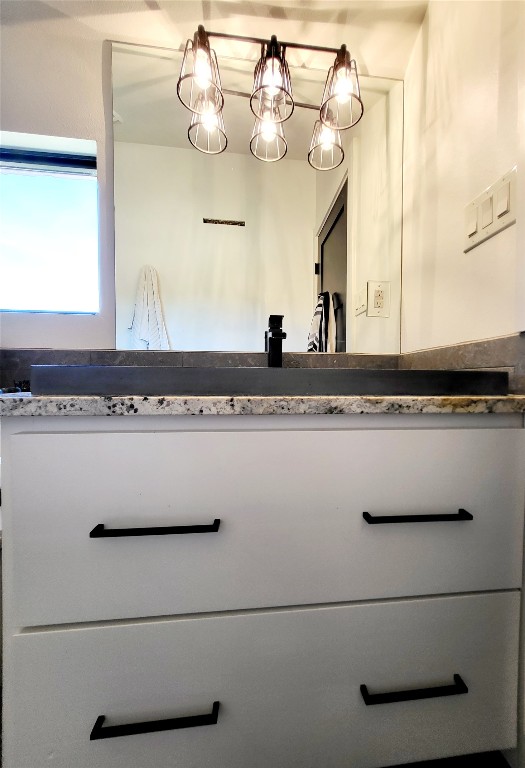 621 Stanton Road Johnson City, TX 78636 - Photo 24 of 40 a bathroom with a sink a mirror and vanity