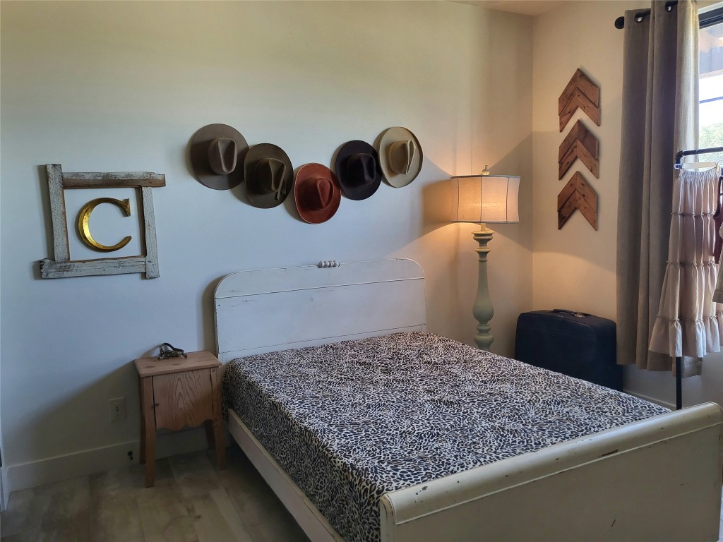 621 Stanton Road Johnson City, TX 78636 - Photo 27 of 40 a bedroom with a bed and painting on the wall