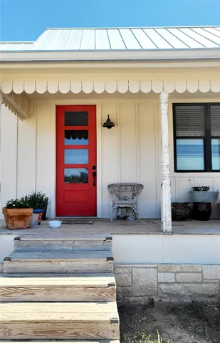 a bedroom with a bed and a flat tv screen on dresser