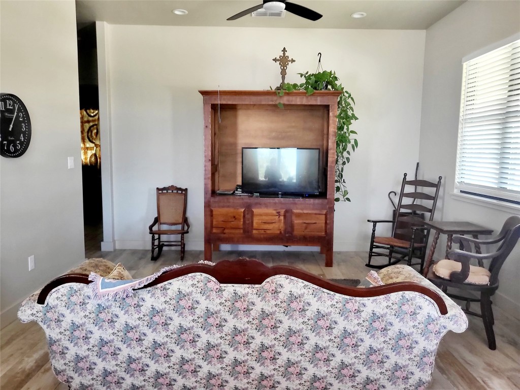 621 Stanton Road Johnson City, TX 78636 - Photo 30 of 40 a bedroom with a bed and a flat tv screen on dresser