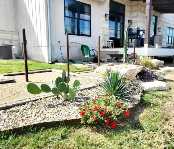 a view of a house with a yard and sitting area