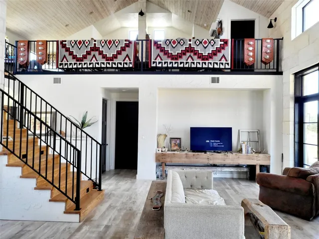a living room with fireplace furniture and a flat screen tv