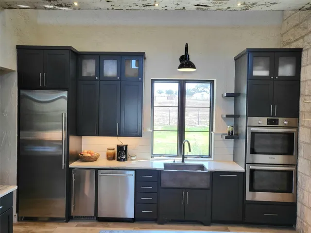 a kitchen with a refrigerator and a sink