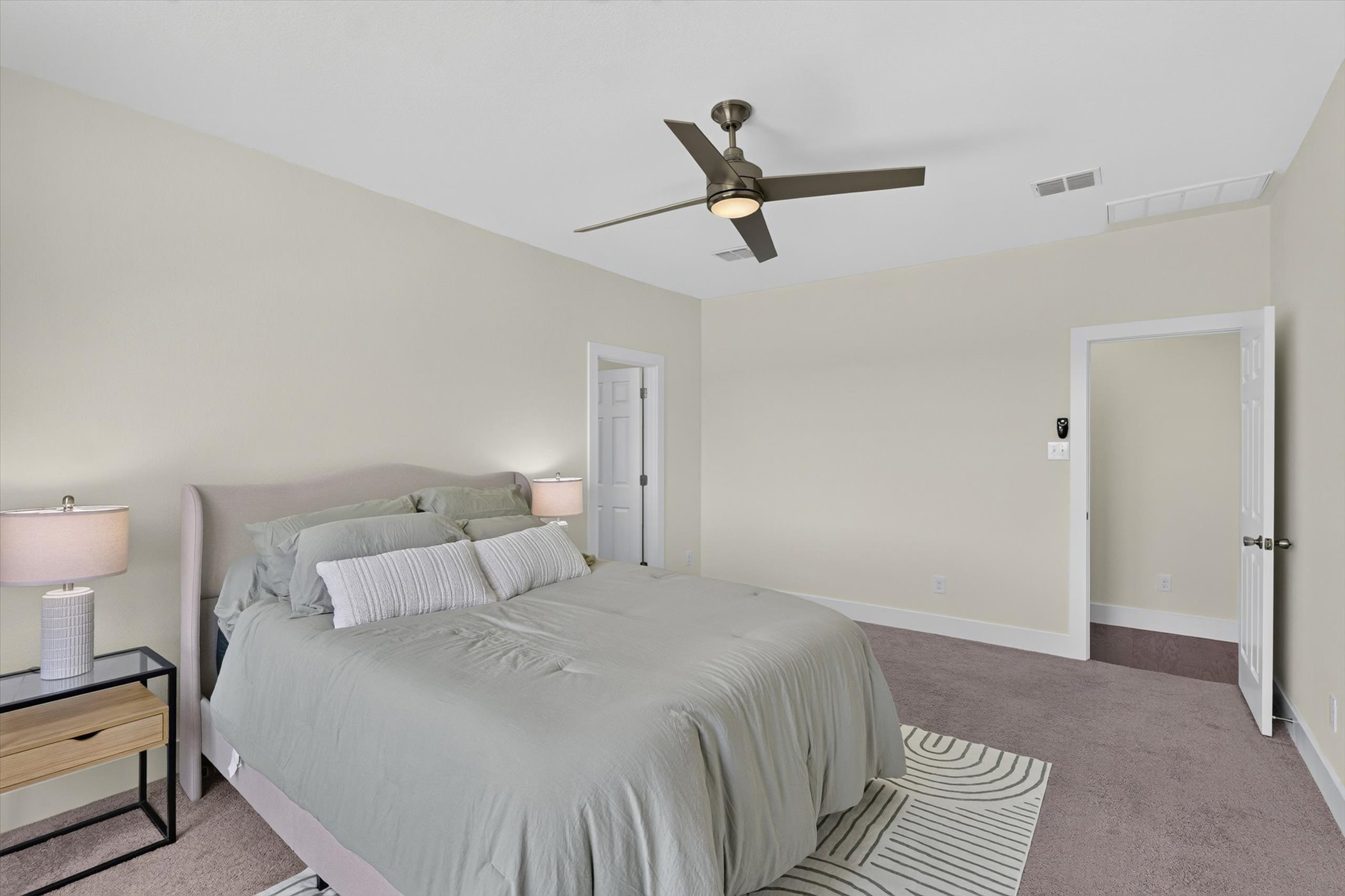 2004 Garretts Way Manchaca, TX 78652 - Photo 16 of 35 Plush wall-to-wall carpeting and clean architectural lines define this serene primary bedroom retreat.