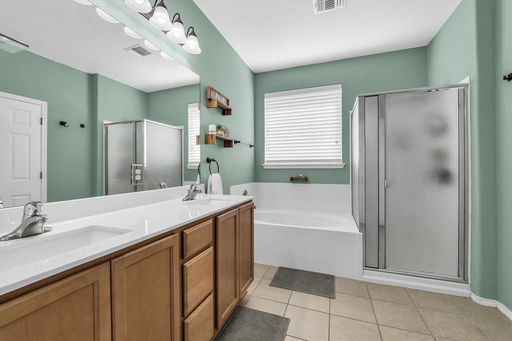 9453 Centennial Drive Waco, TX 76708 - Photo 19 of 37 a bathroom with a sink double vanity granite tub shower and a mirror
