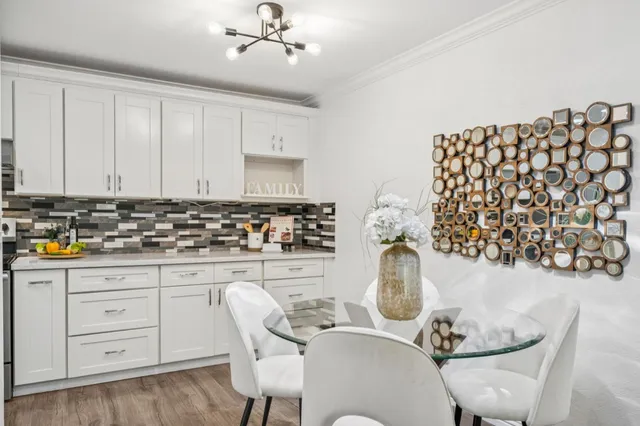 a kitchen with granite countertop a white cabinets and white appliances