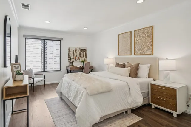 a bedroom with a large bed and a window