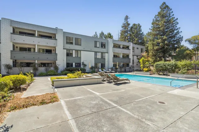 a swimming pool with outdoor seating and yard