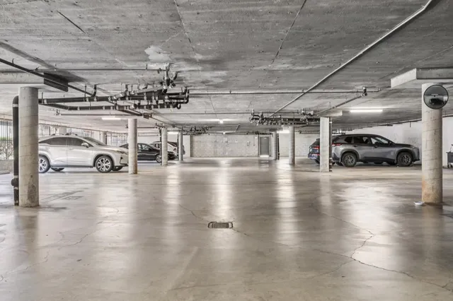 a view of parking garage with cars parked