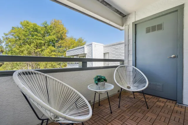 a view of a chair and table in the balcony