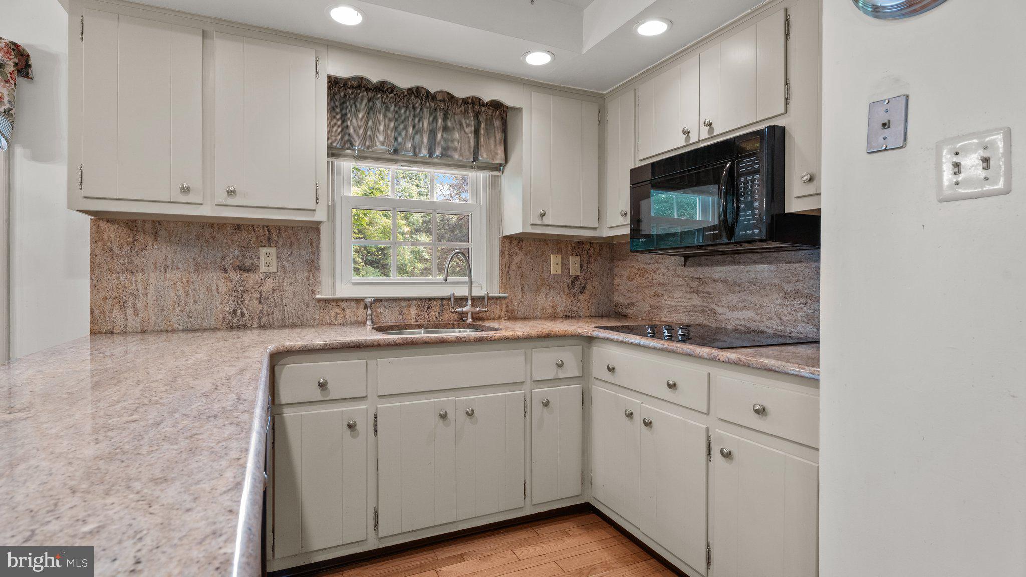 741 Spring Valley Road Doylestown, PA 18901 - Photo 12 of 41 a kitchen with white cabinets appliances and a sink