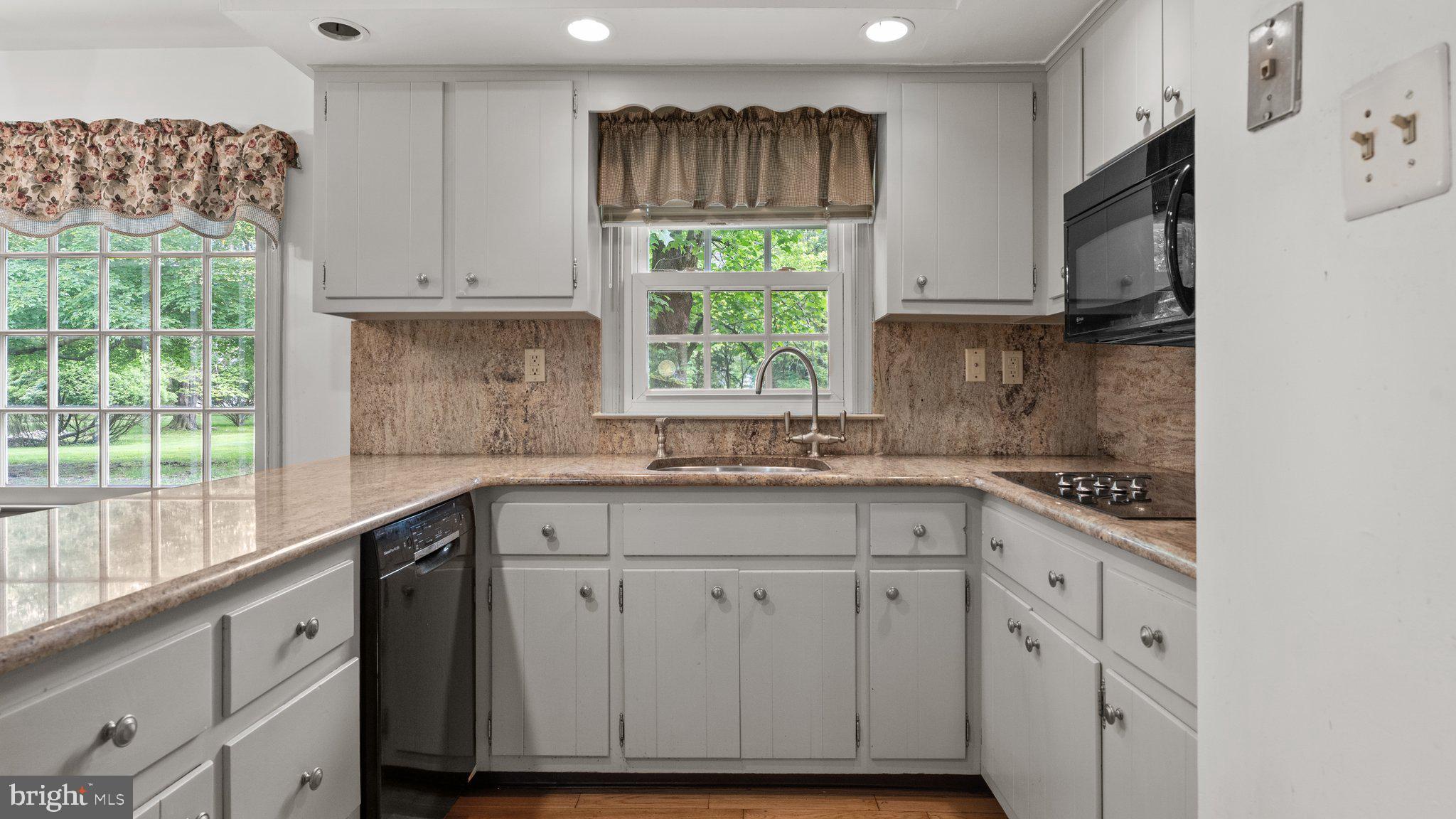 741 Spring Valley Road Doylestown, PA 18901 - Photo 16 of 41 a kitchen with white cabinets and a window