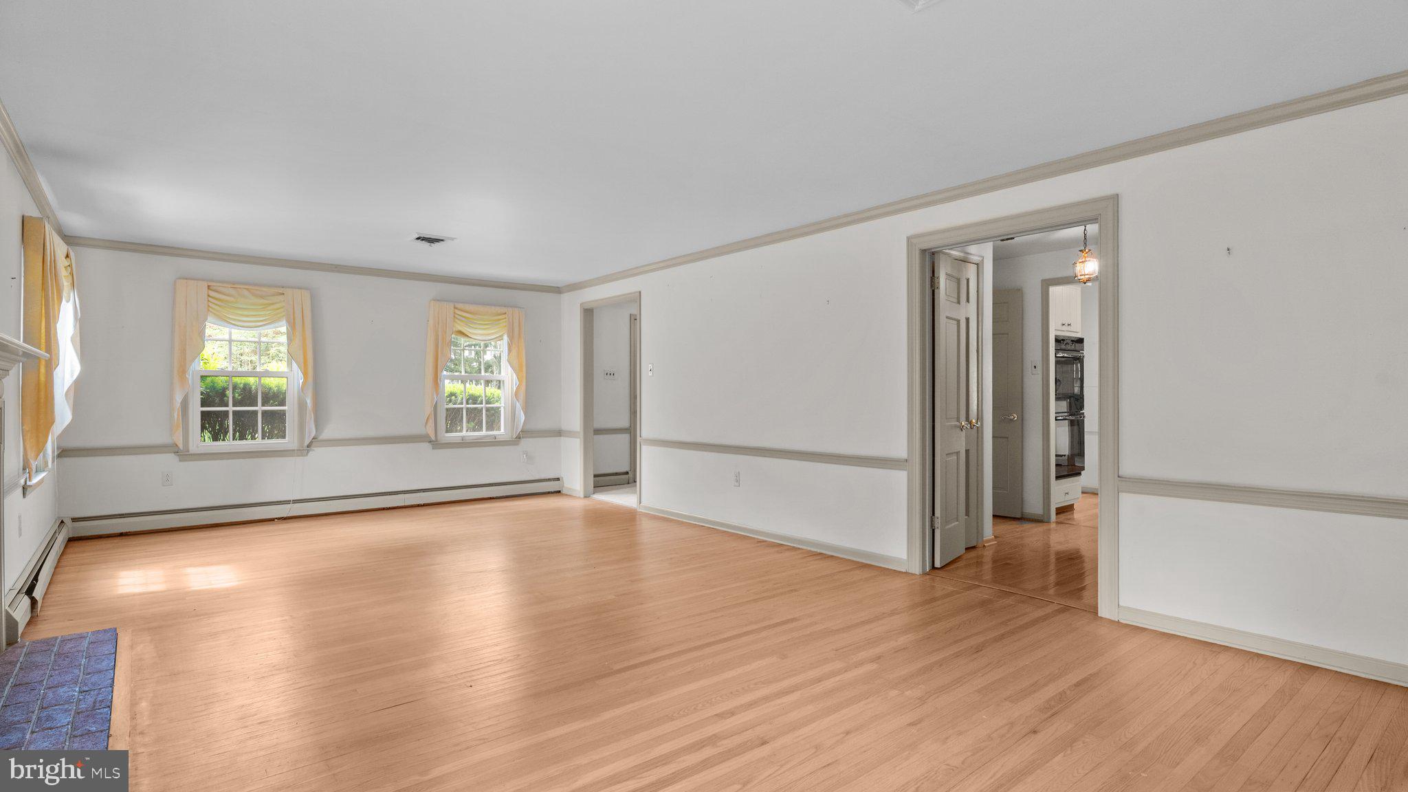 741 Spring Valley Road Doylestown, PA 18901 - Photo 22 of 41 an empty room with wooden floor and windows