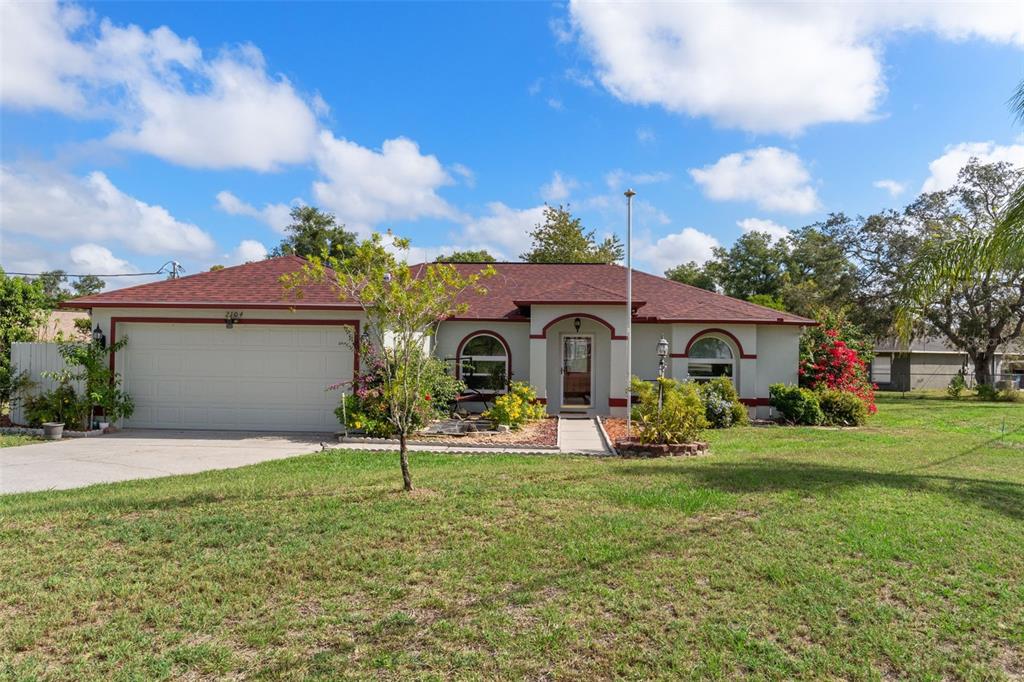 2104 Linwood Avenue Spring Hill, FL 34608 - Photo 1 of 44 a front view of house with outdoor seating and green space
