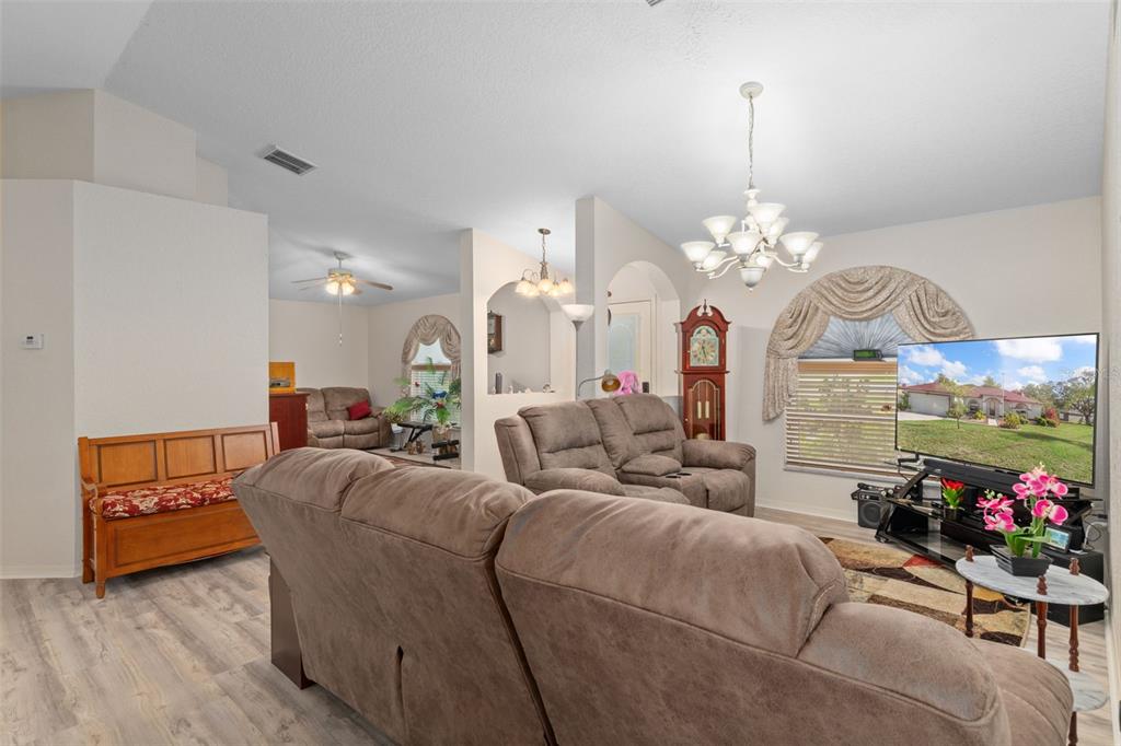 2104 Linwood Avenue Spring Hill, FL 34608 - Photo 11 of 44 a living room with furniture and a chandelier