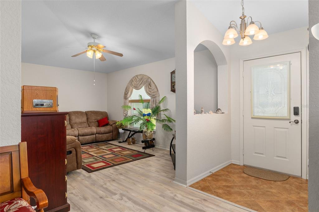 2104 Linwood Avenue Spring Hill, FL 34608 - Photo 12 of 44 a living room with furniture and a chandelier