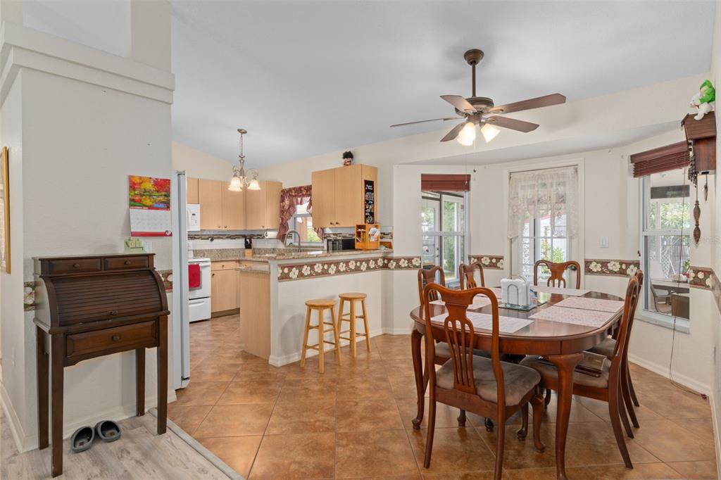 2104 Linwood Avenue Spring Hill, FL 34608 - Photo 14 of 44 a dining hall with stainless steel appliances kitchen island granite countertop furniture and a window
