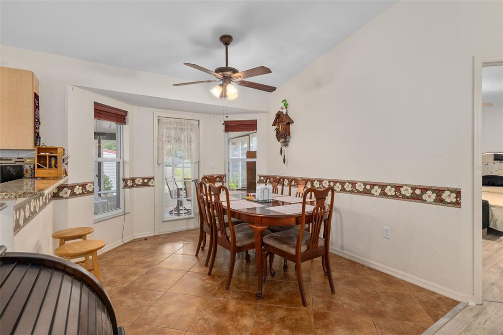 2104 Linwood Avenue Spring Hill, FL 34608 - Photo 15 of 44 a view of a dining room with furniture and a chandelier