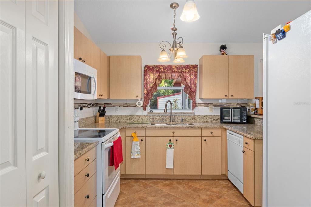 2104 Linwood Avenue Spring Hill, FL 34608 - Photo 18 of 44 a kitchen with a sink stove and cabinets