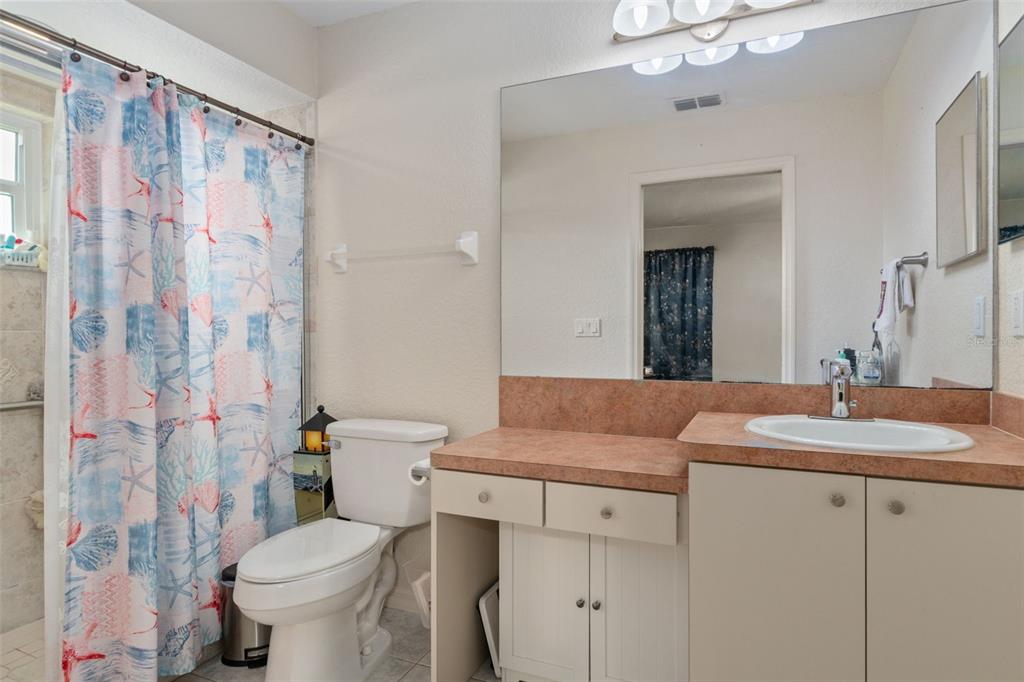 2104 Linwood Avenue Spring Hill, FL 34608 - Photo 23 of 44 a bathroom with a granite countertop sink toilet and shower