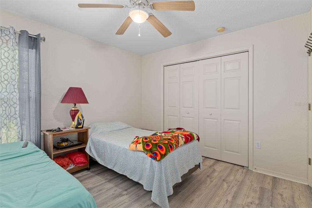 2104 Linwood Avenue Spring Hill, FL 34608 - Photo 27 of 44 a bedroom with a bed and a chandelier