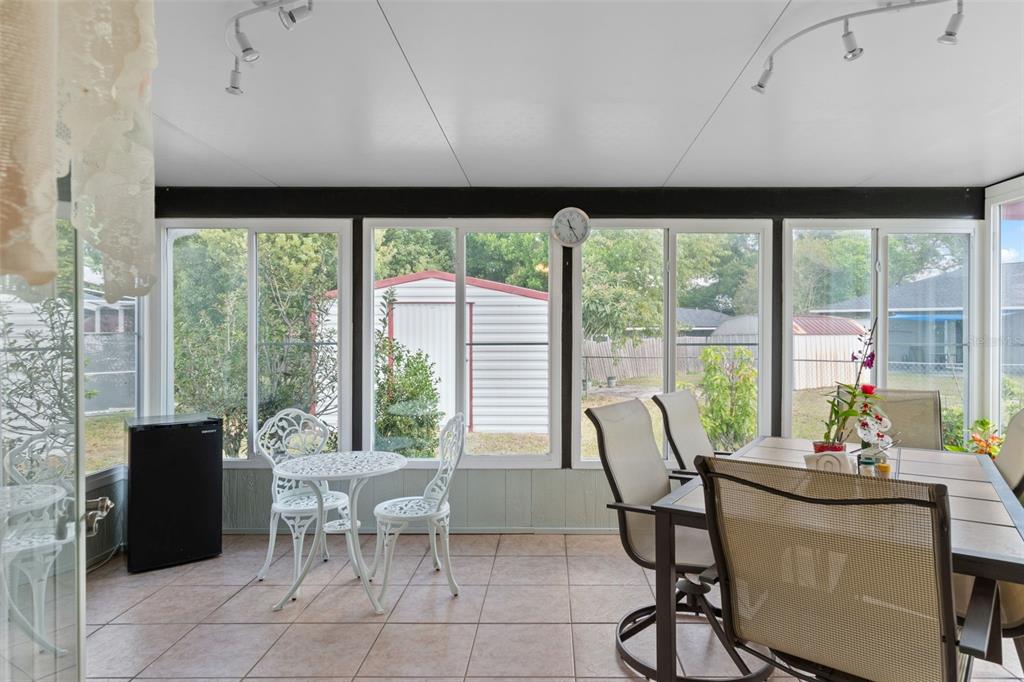 2104 Linwood Avenue Spring Hill, FL 34608 - Photo 34 of 44 a dining room with furniture water view and a floor to ceiling window