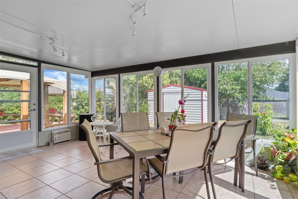 2104 Linwood Avenue Spring Hill, FL 34608 - Photo 36 of 44 a view of a dining room with furniture large windows and wooden floor