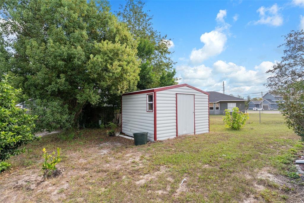 2104 Linwood Avenue Spring Hill, FL 34608 - Photo 42 of 44 a view of a house with a yard and garage