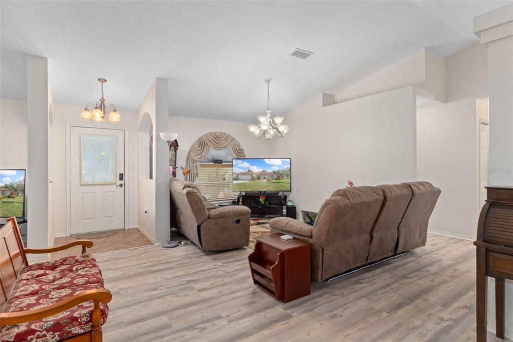 2104 Linwood Avenue Spring Hill, FL 34608 - Photo 9 of 44 a living room with furniture chandelier and a chandelier