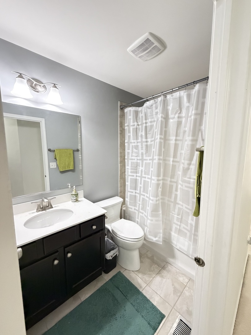 2911 Henley Lane, Unit 2911 Naperville, IL 60540 - Photo 15 of 23 a bathroom with a double vanity sink toilet and shower