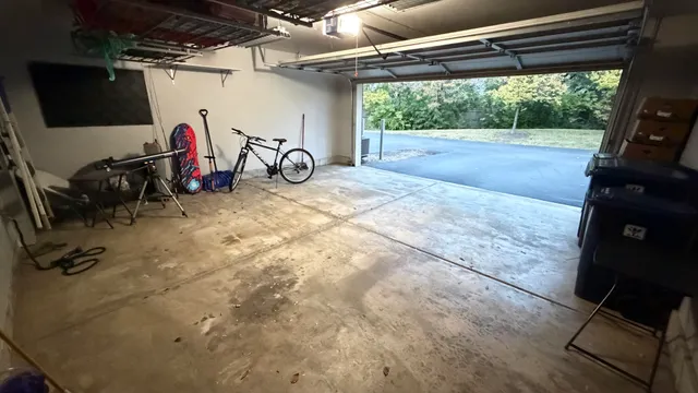 a view of a garage with wooden floor and stairs