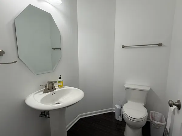 a bathroom with a toilet sink and mirror