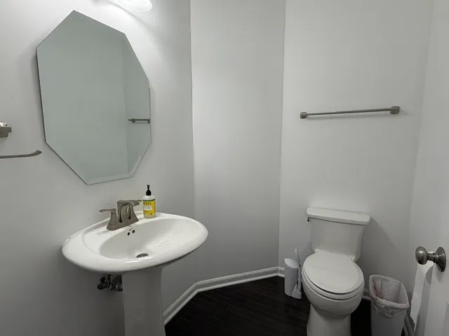 a bathroom with a toilet sink and mirror