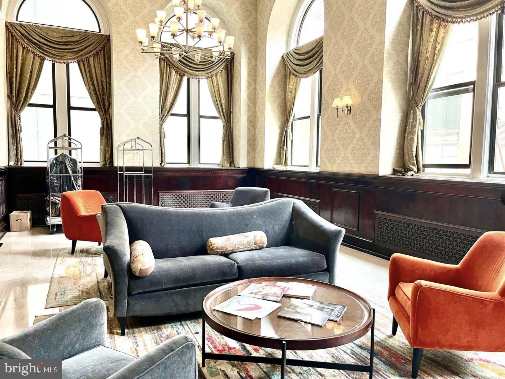 1324-00 Locust Street, Unit 1017 Philadelphia, PA 19107 - Photo 2 of 13 a living room with furniture and a large window