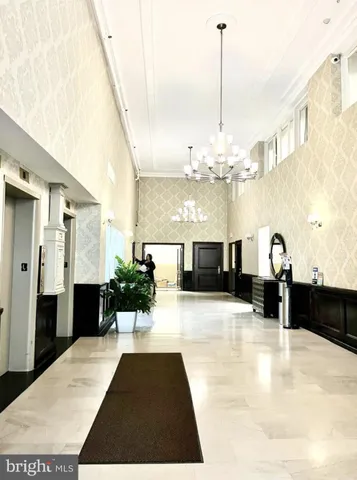 a view of a living room with furniture and a chandelier