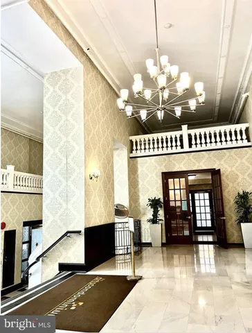 a view of a lobby with furniture and chandelier