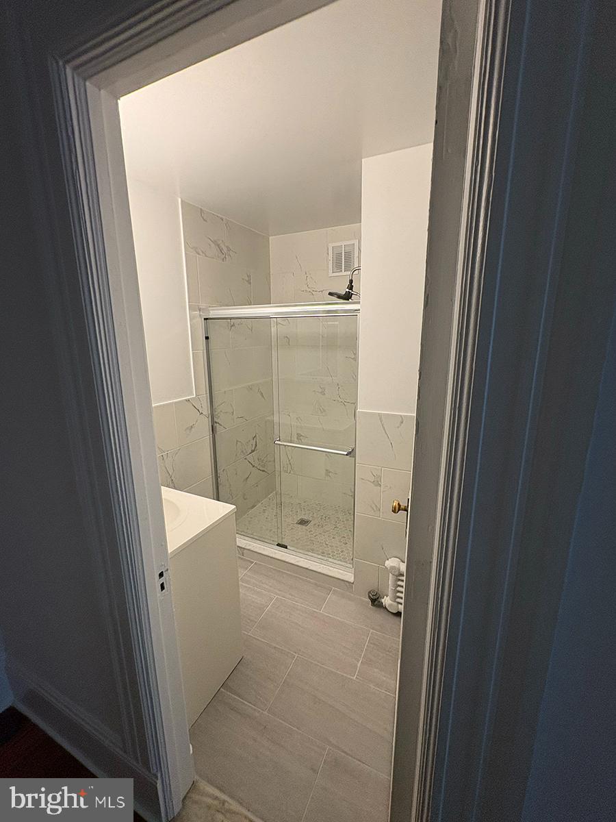 1324-00 Locust Street, Unit 1017 Philadelphia, PA 19107 - Photo 8 of 13 a bathroom with a shower and toilet