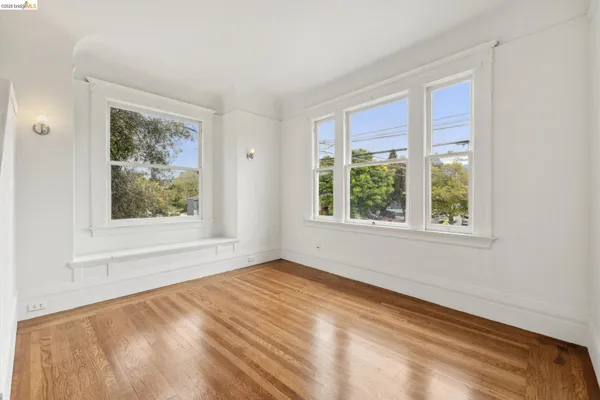 a bedroom with a bed lamp and a window