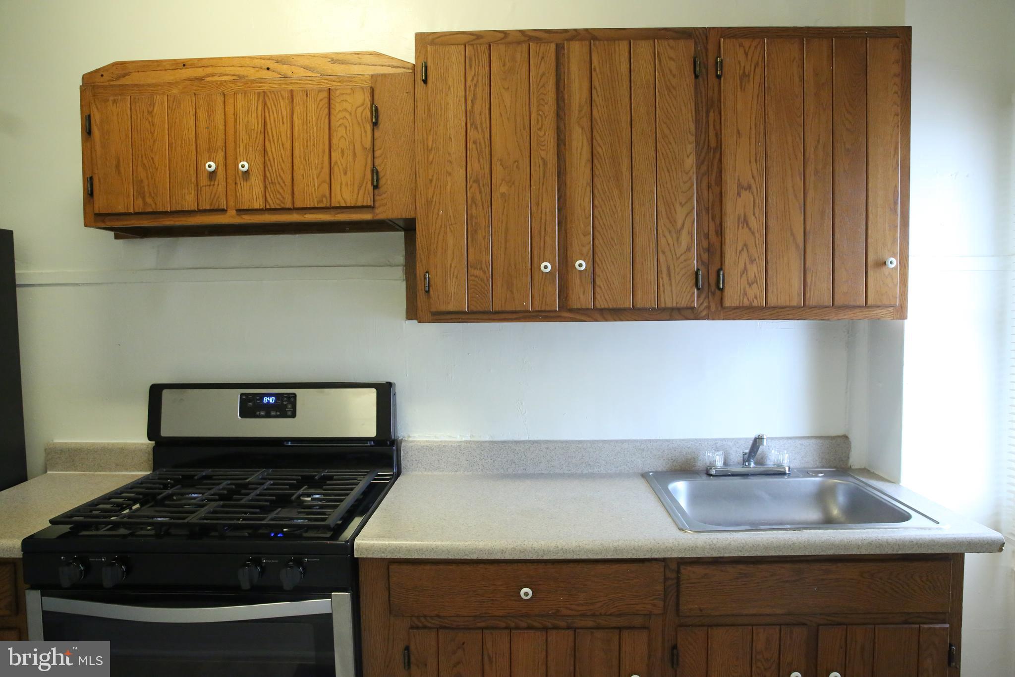 4852 Pimlico Road Baltimore, MD 21215 - Photo 13 of 40 a kitchen with granite countertop a stove