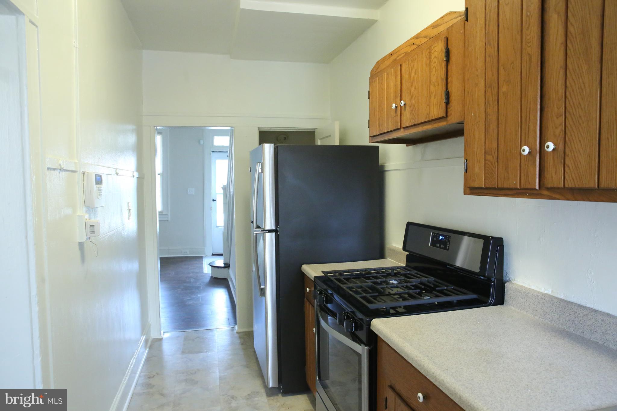4852 Pimlico Road Baltimore, MD 21215 - Photo 14 of 40 a kitchen with stainless steel appliances granite countertop a refrigerator and a stove