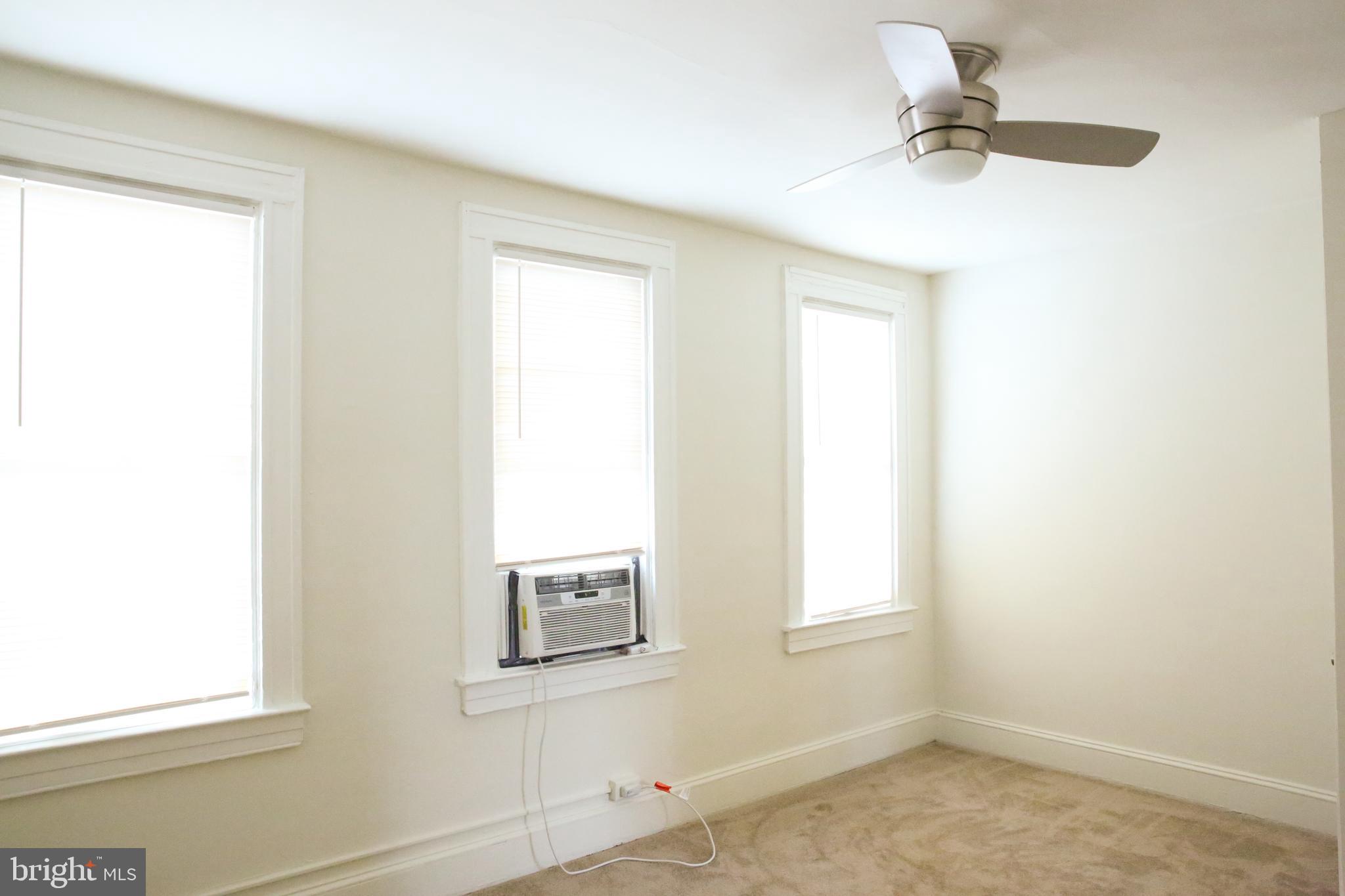 4852 Pimlico Road Baltimore, MD 21215 - Photo 17 of 40 a bathroom with a window and a ceiling fan