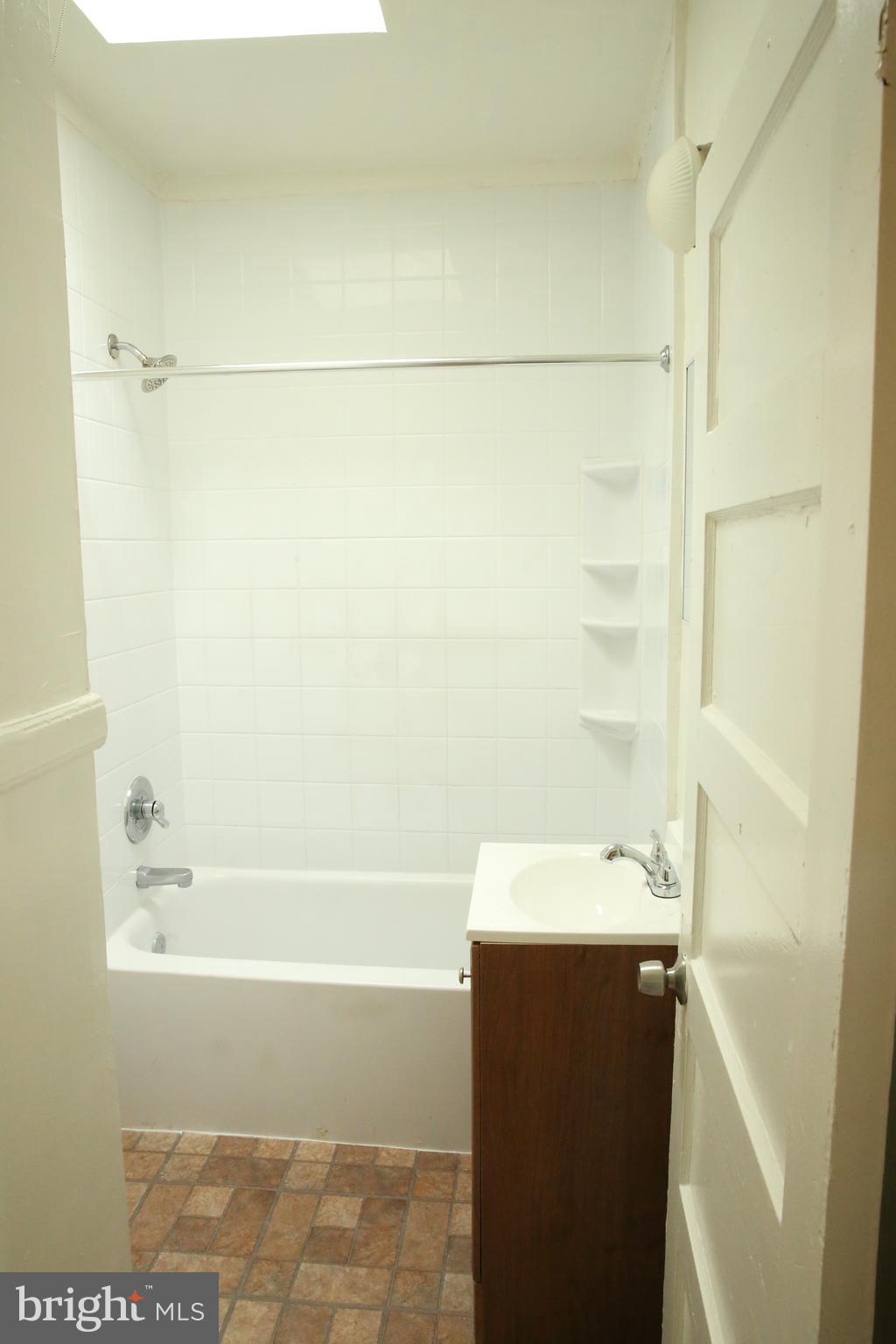 4852 Pimlico Road Baltimore, MD 21215 - Photo 22 of 40 a bathroom with a sink and a bathtub