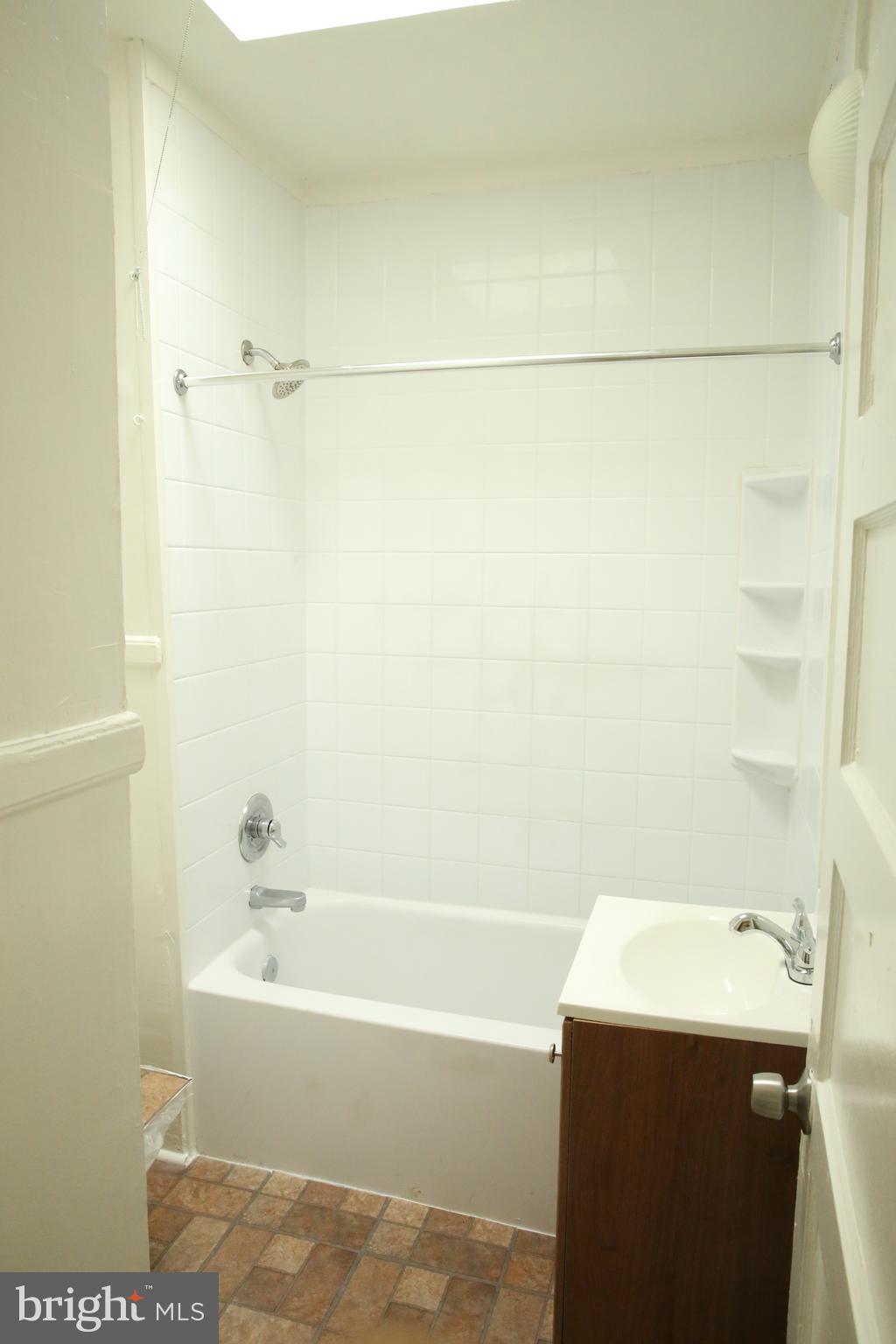 4852 Pimlico Road Baltimore, MD 21215 - Photo 23 of 40 a bathroom with a sink and a bathtub